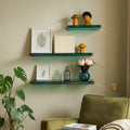 Green acrylic floating shelves mounted on a wall