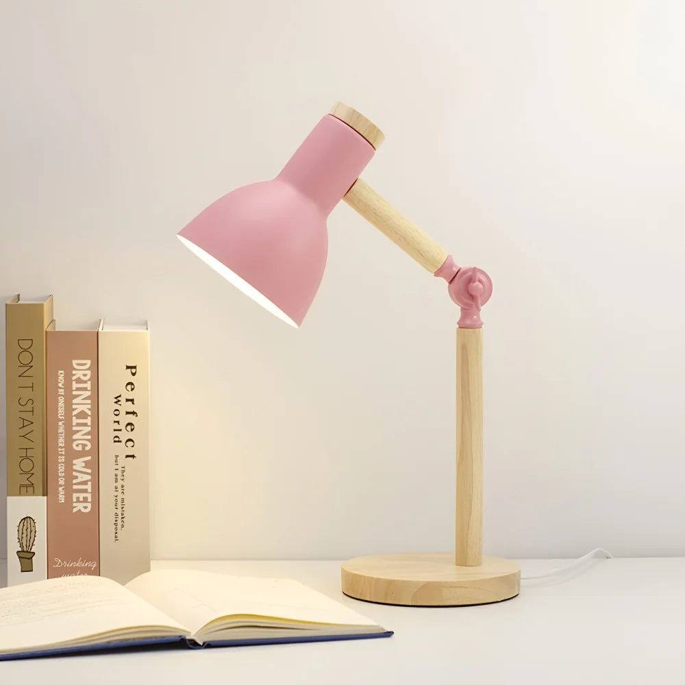 Pink desk lamp angled over an open book