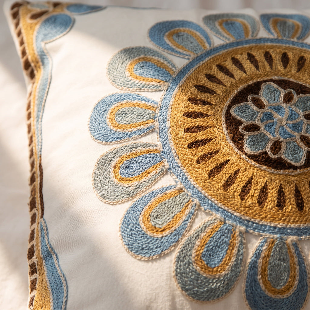 Close-up of the blue and gold medallion embroidery of the Aurelia cushion, Style Room