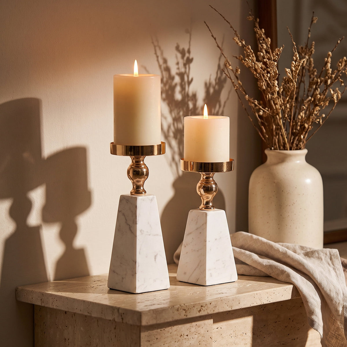 Both Aurum heights standing as a pair on a travertine console with lit candles, Style Room