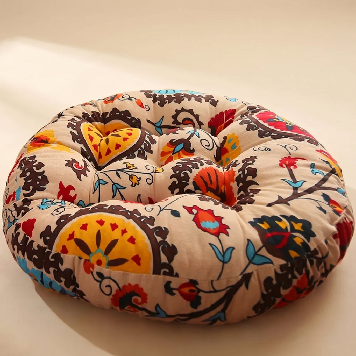 Bela round cushion in cream cotton linen with folk floral print and gathered centre, Style Room