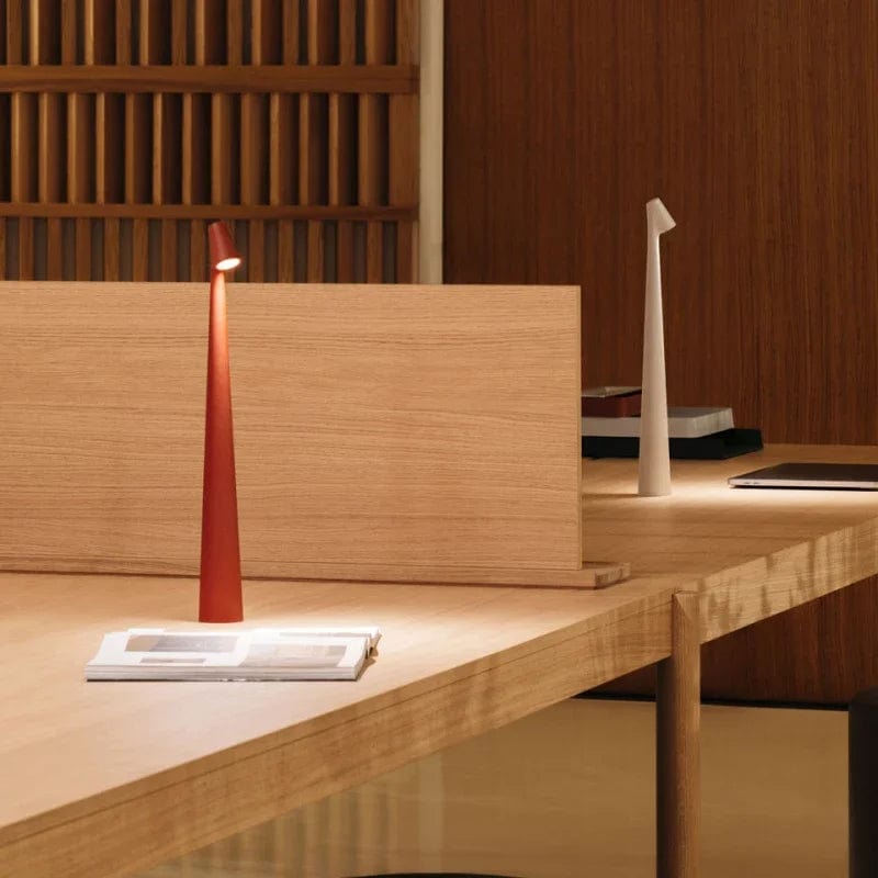 Red and white Bexley table lamps lit on a long wooden desk