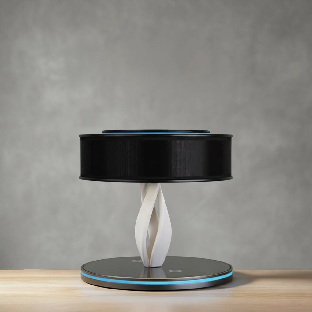 Bexon table lamp in black on a wooden surface, drum shade on a twisted column with a lit base ring