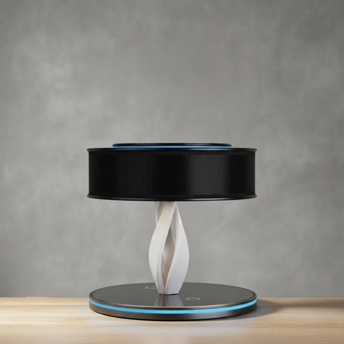 Bexon table lamp in black on a wooden surface, drum shade on a twisted column with a lit base ring