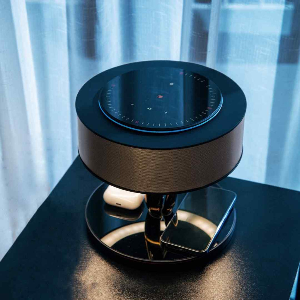 Bexon table lamp on a black nightstand with earbuds resting on the charging surface