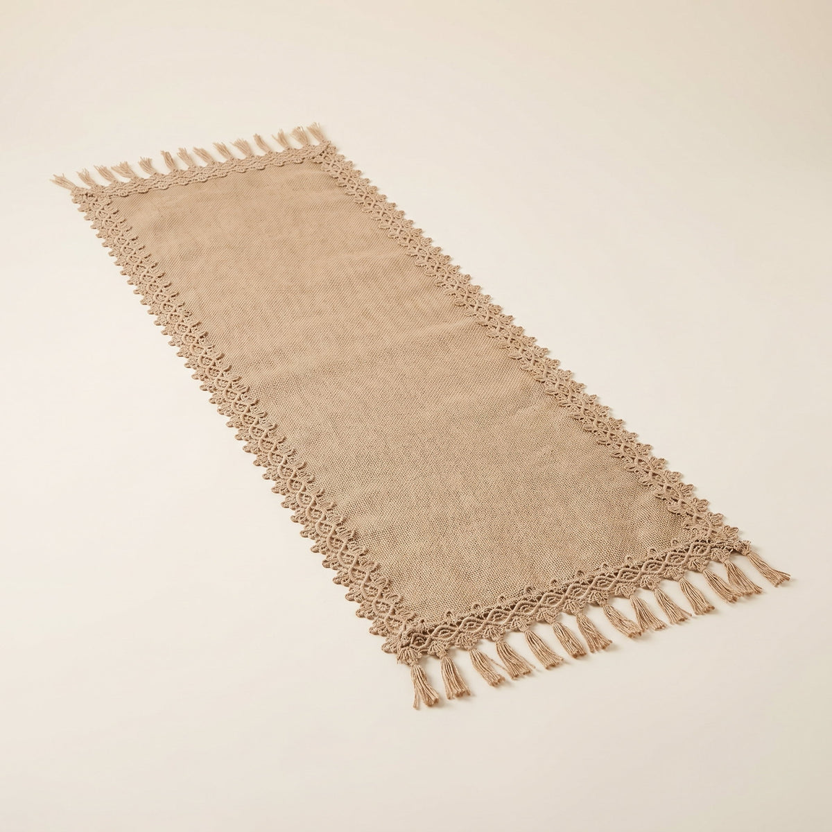 Bramble natural jute table runner laid flat with a tasselled edge, full view