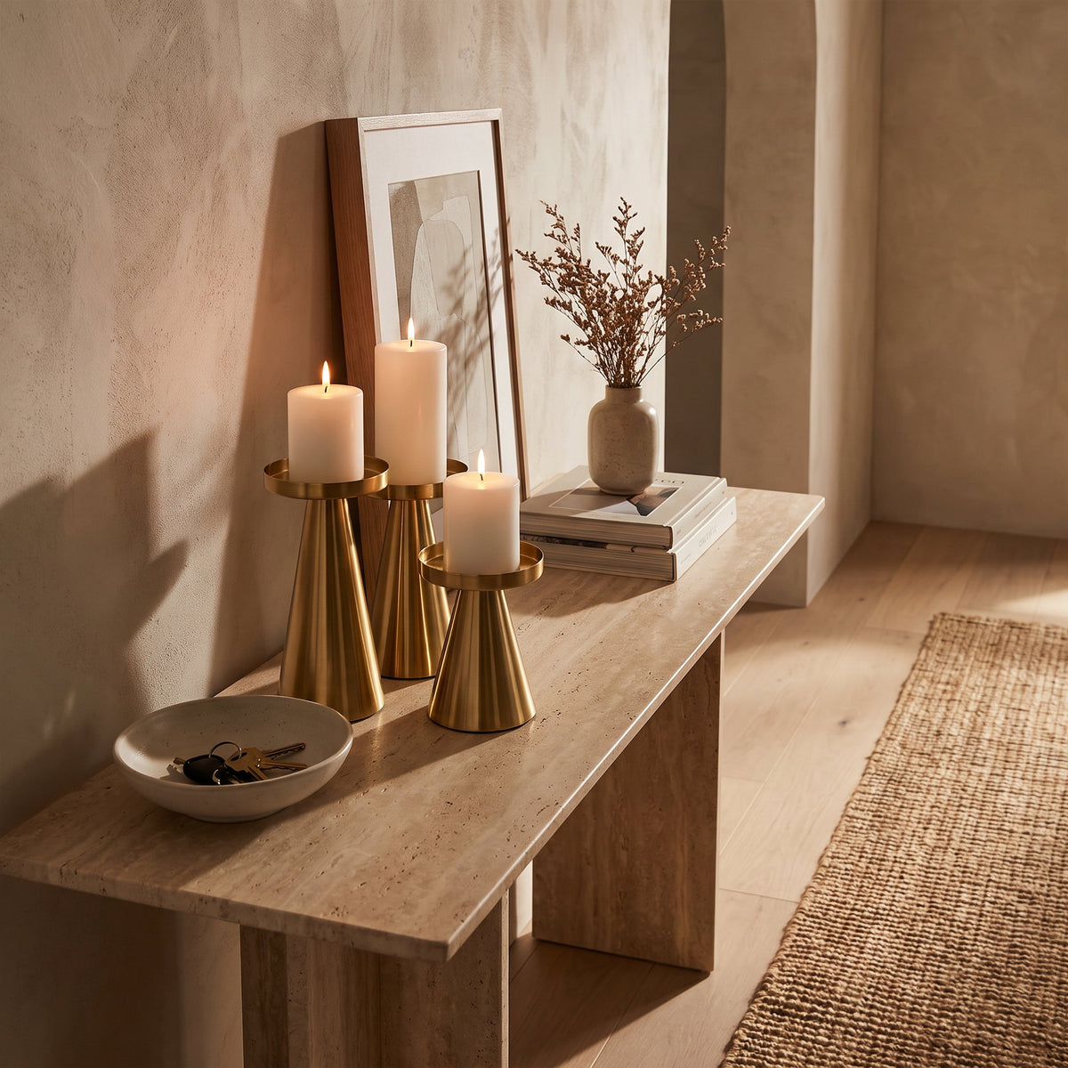 Brenna gold candle stands lit on a travertine console, Style Room