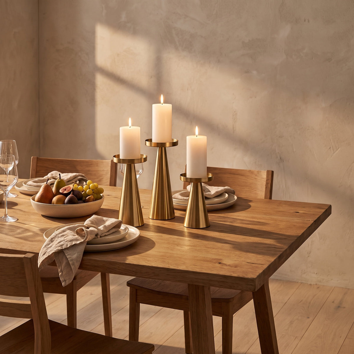 Brenna gold candle stands lit on a laid dining table, Style Room