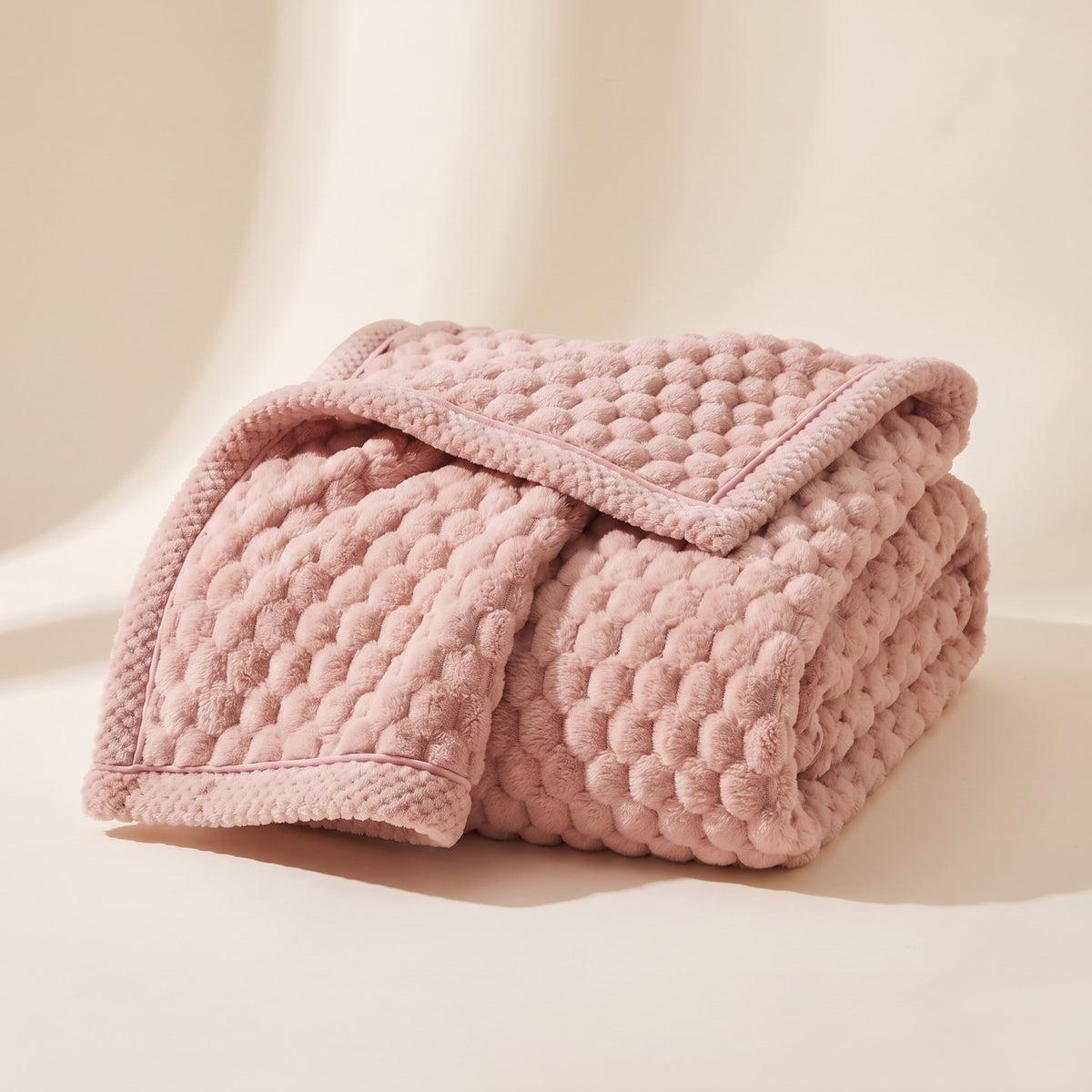 Cielo plush blanket in blush pink, bubble-textured sherpa fleece, folded, Style Room