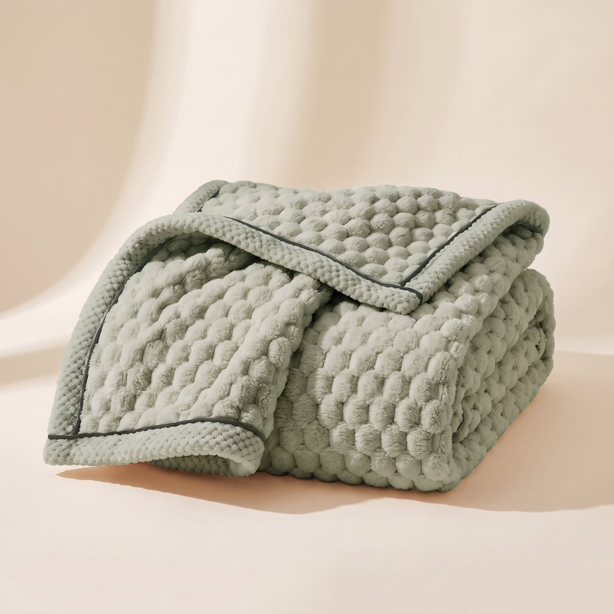 Cielo plush blanket in matcha green, bubble-textured sherpa fleece, folded, Style Room