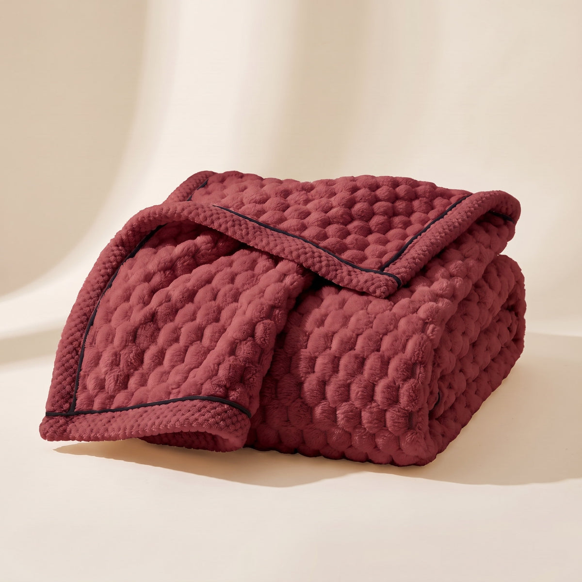 Cielo plush blanket in velvet red, bubble-textured sherpa fleece, folded, Style Room