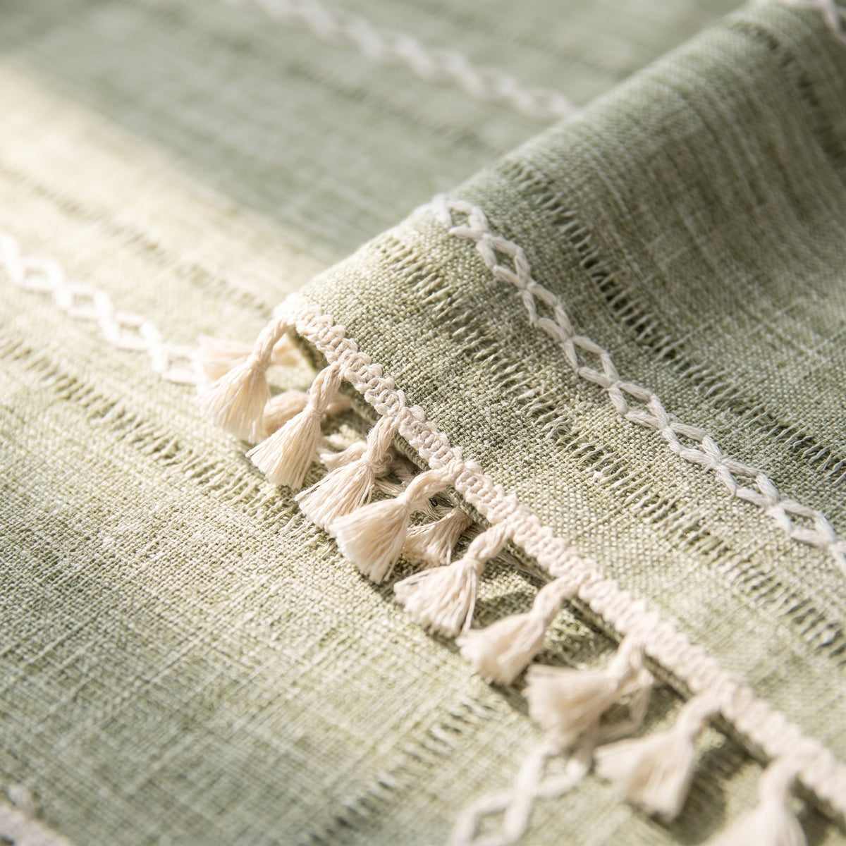 Close-up of the stripe embroidery and tassel lace of the Cora tablecloth, Style Room