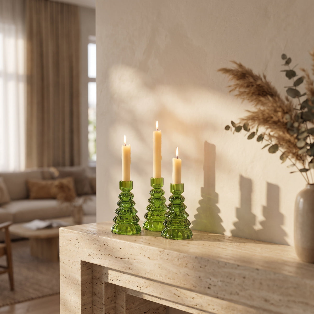 Cresta green glass candle holders styled on a travertine mantel in a calm cream living room