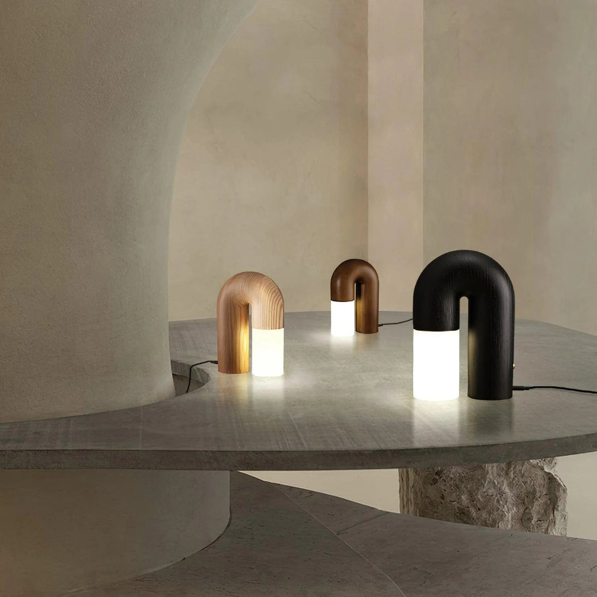 Diora table lamp lit, showing the glow spilling from under the wooden arch