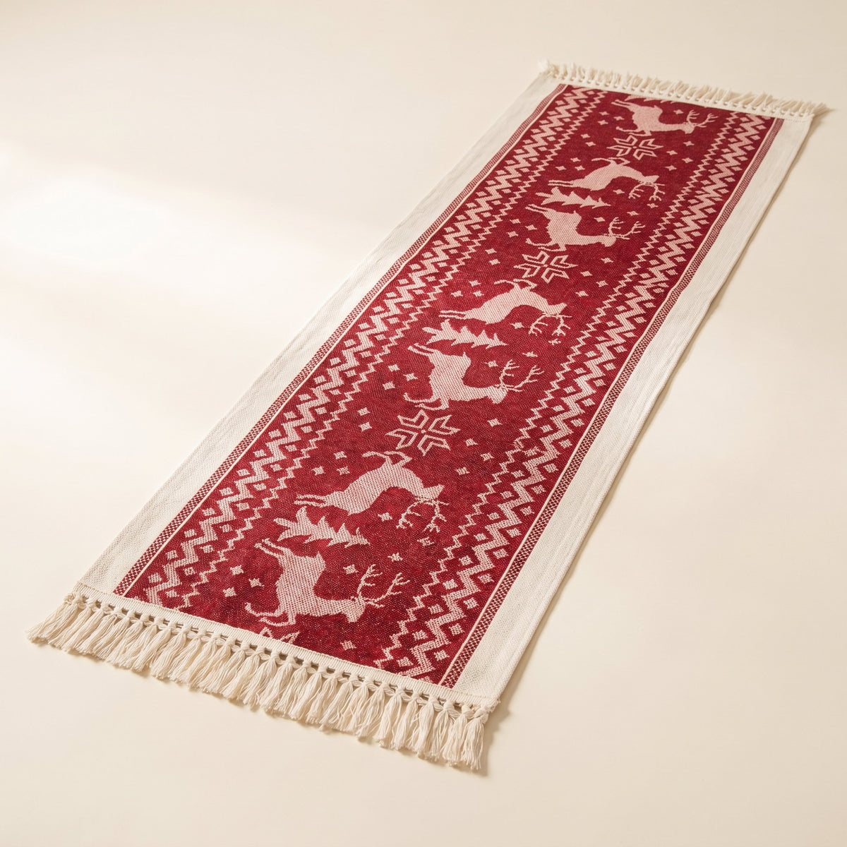 Eldon elk table runner in red and cream microfiber jacquard with tasselled edges on a cream background, Style Room