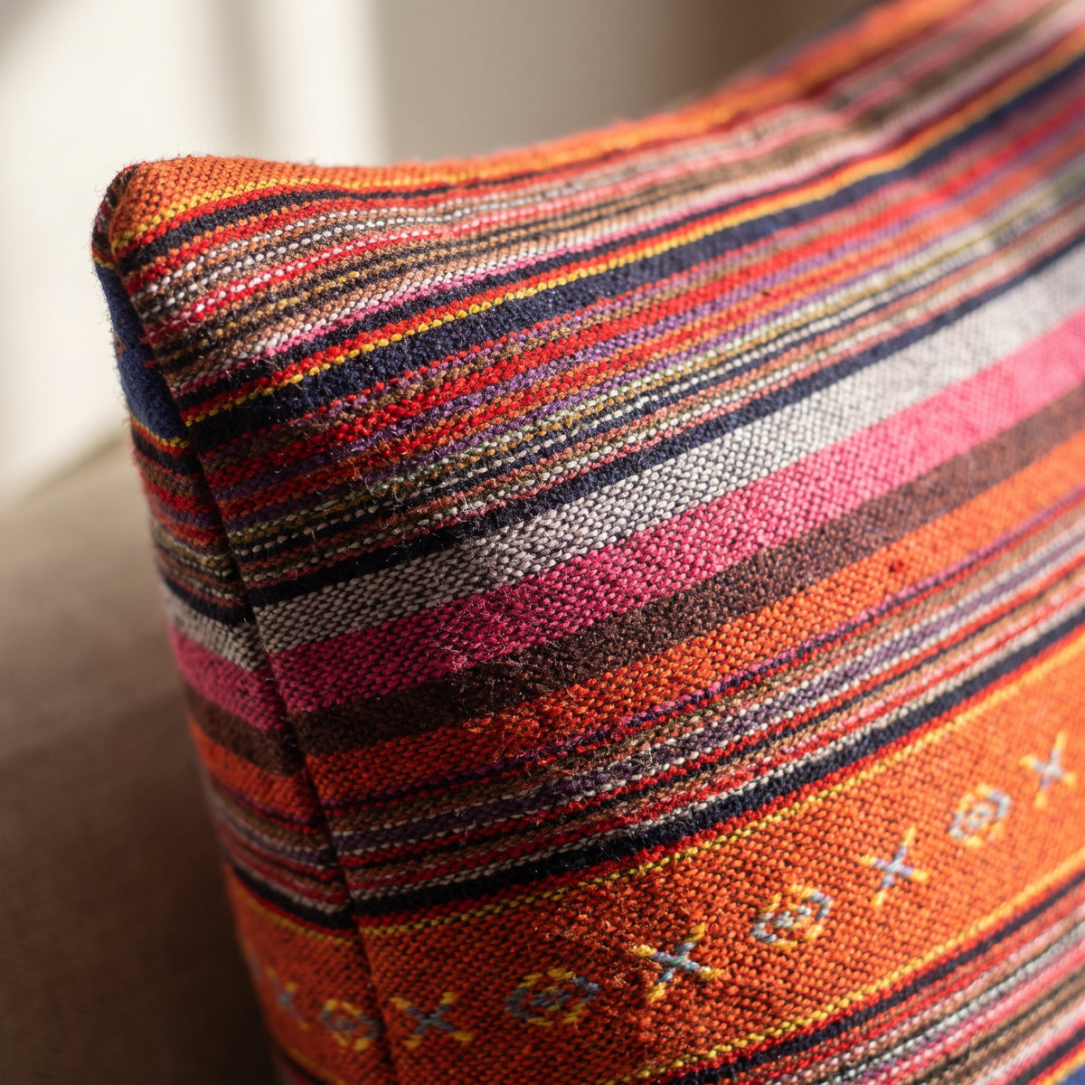 Close-up of the woven stripe and diamond motifs of the Evoa cushion, Style Room