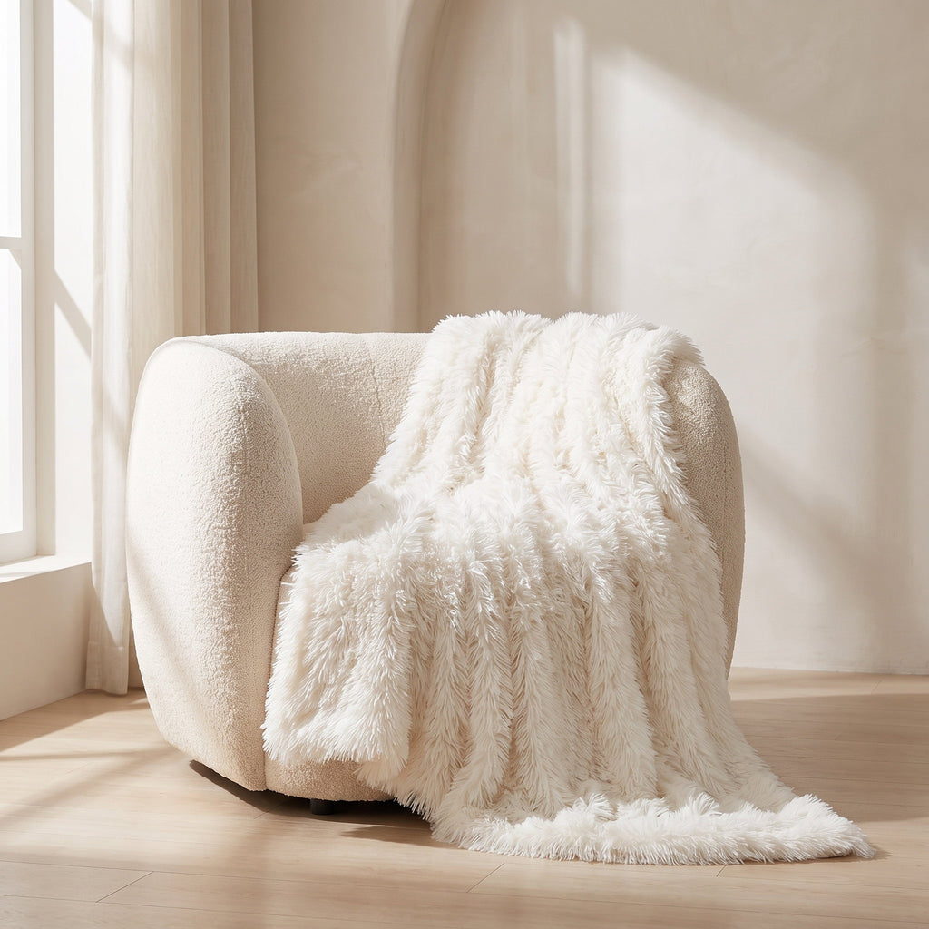 Fiona ivory faux fur throw draped over a cream boucle armchair, Style Room