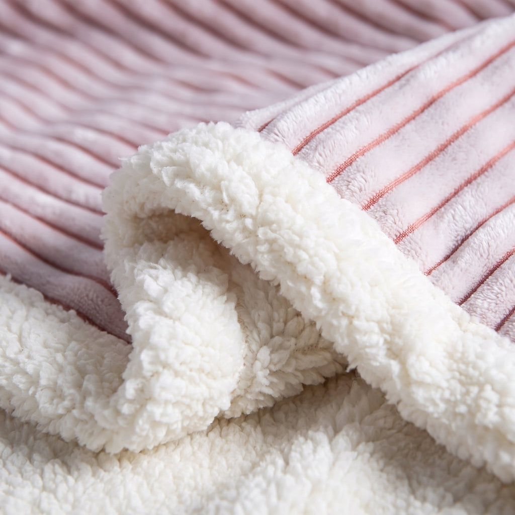 Close-up of the ribbed stripes and sherpa reverse of the Fiora blanket, Style Room