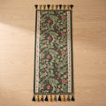 Fiora vine table runner in forest green lying flat with embroidered acanthus vine and tassels at both ends, Style Room