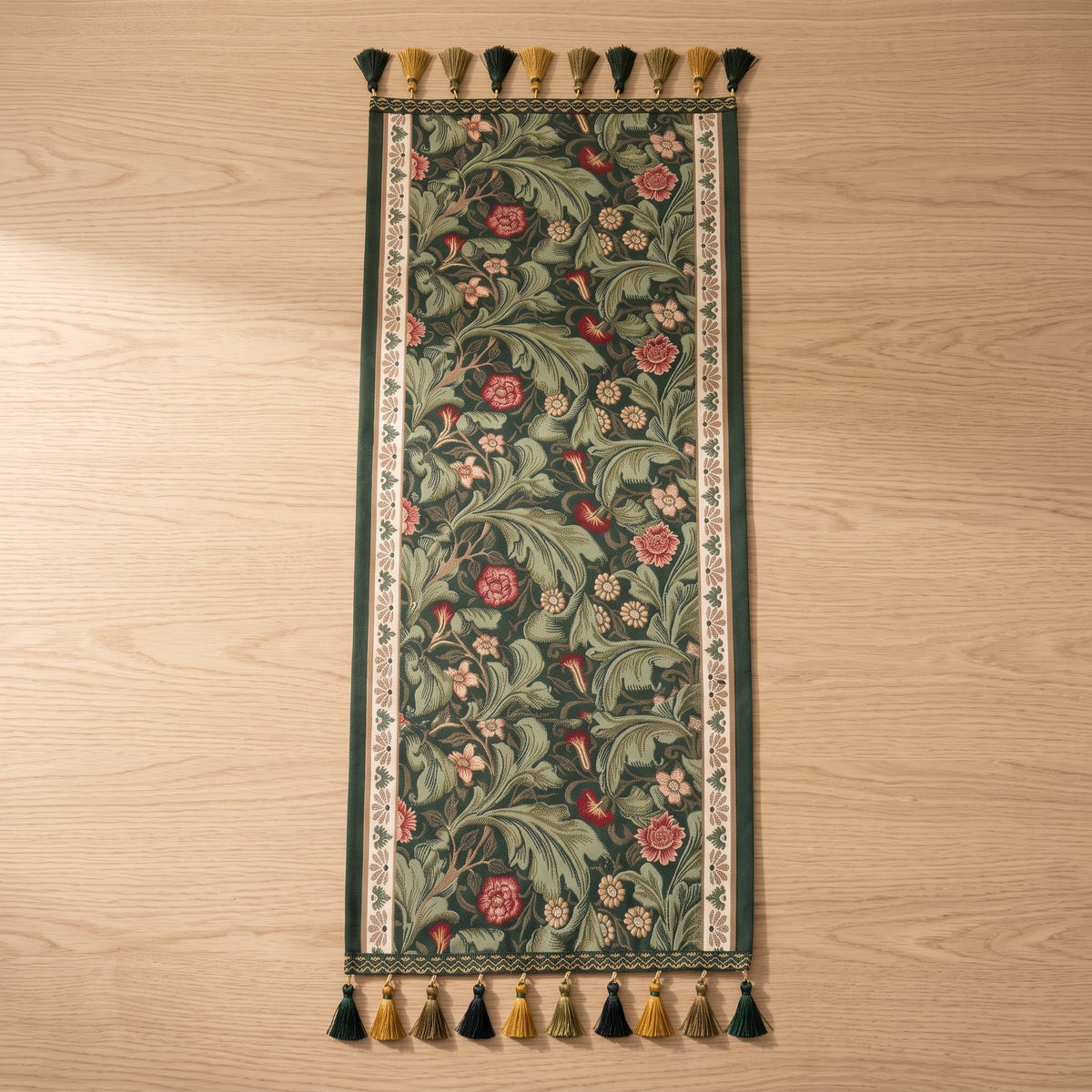 Fiora vine table runner in forest green lying flat with embroidered acanthus vine and tassels at both ends, Style Room