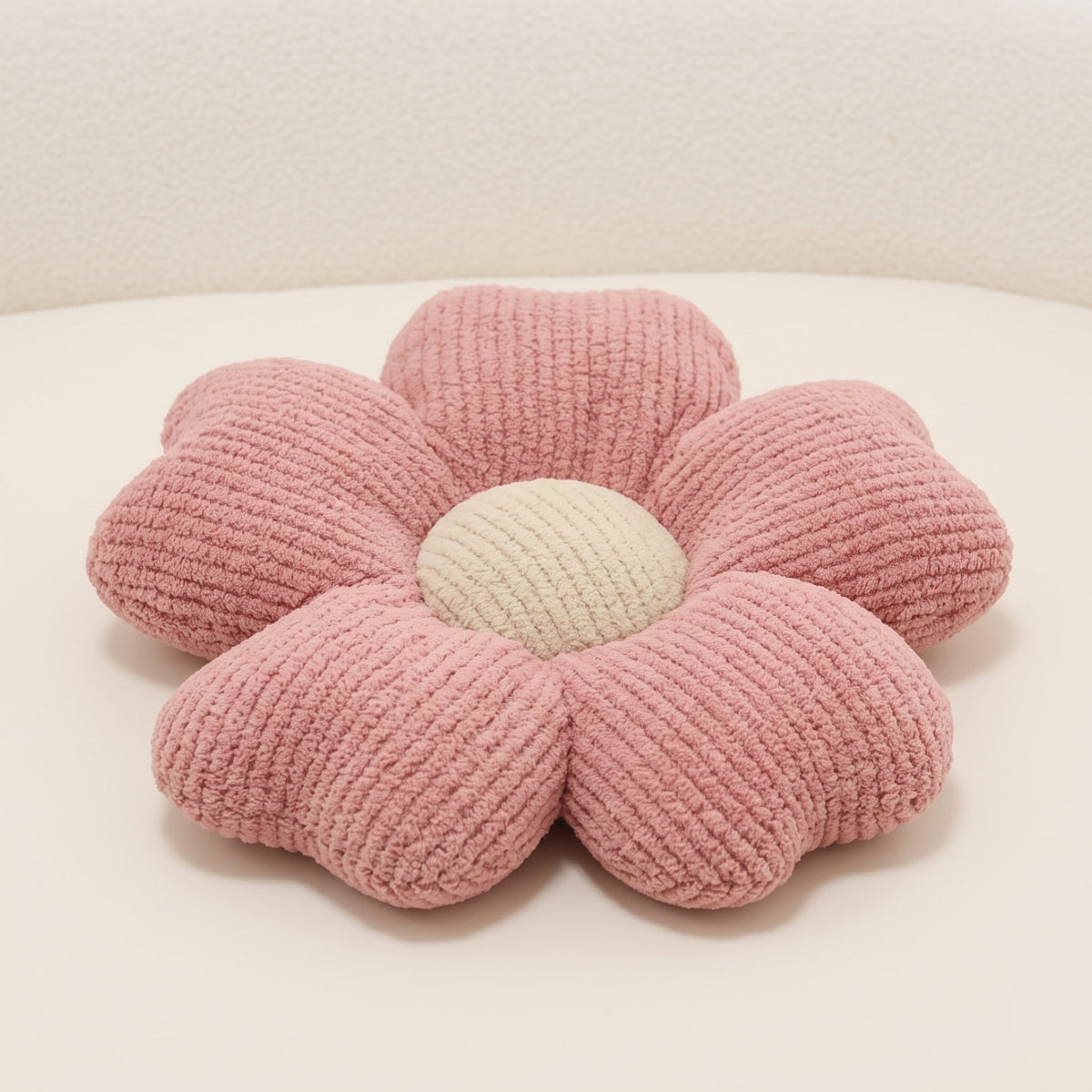 Flora flower cushion in dusty pink chunky knit with six petals and cream centre, Style Room