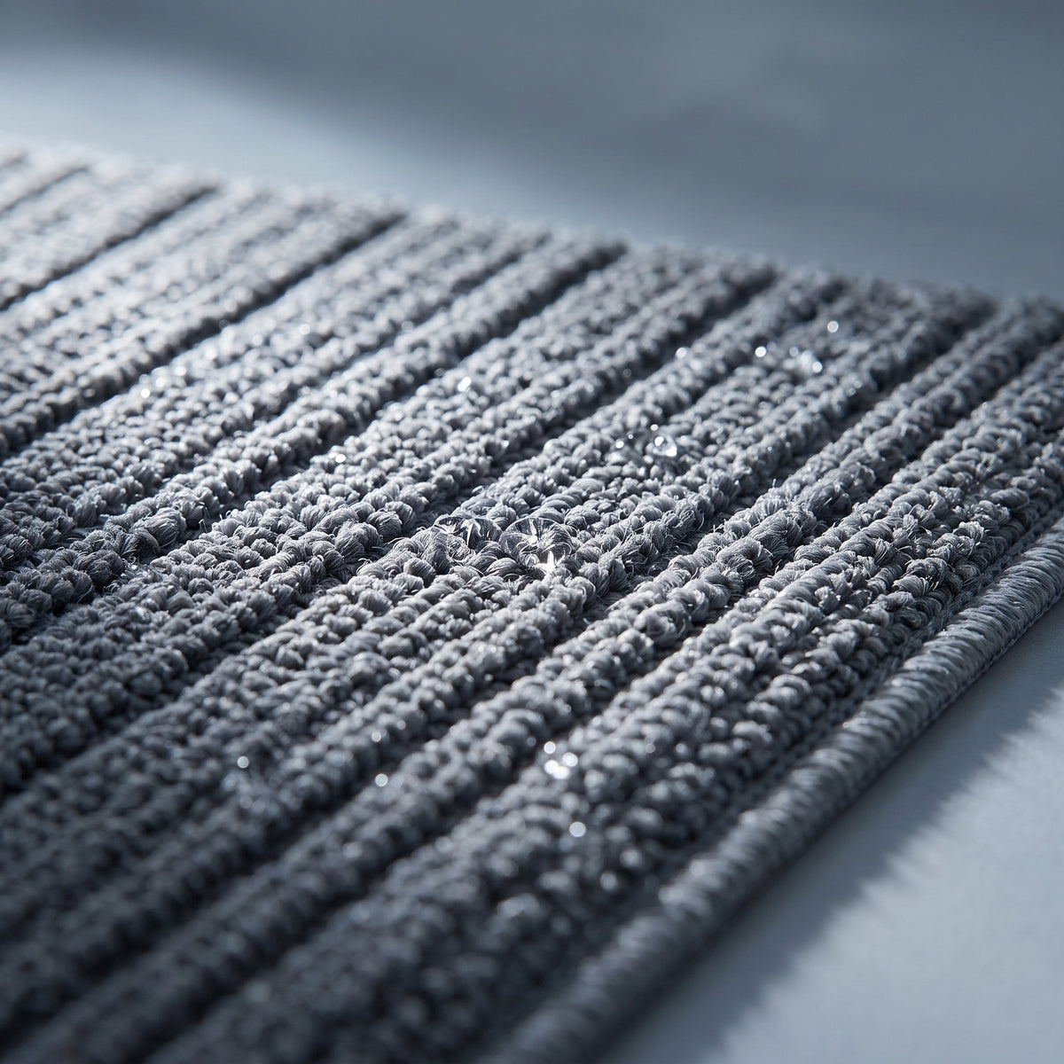 Close detail of the dense ribbed pile of the Halden entrance mat, Style Room