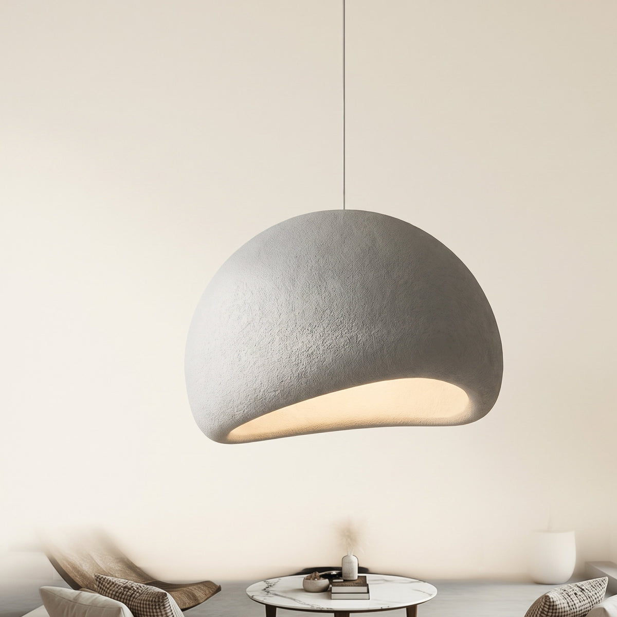 Halo dome pendant light with an asymmetric matt shade, lit, hanging against a pale background, Style Room