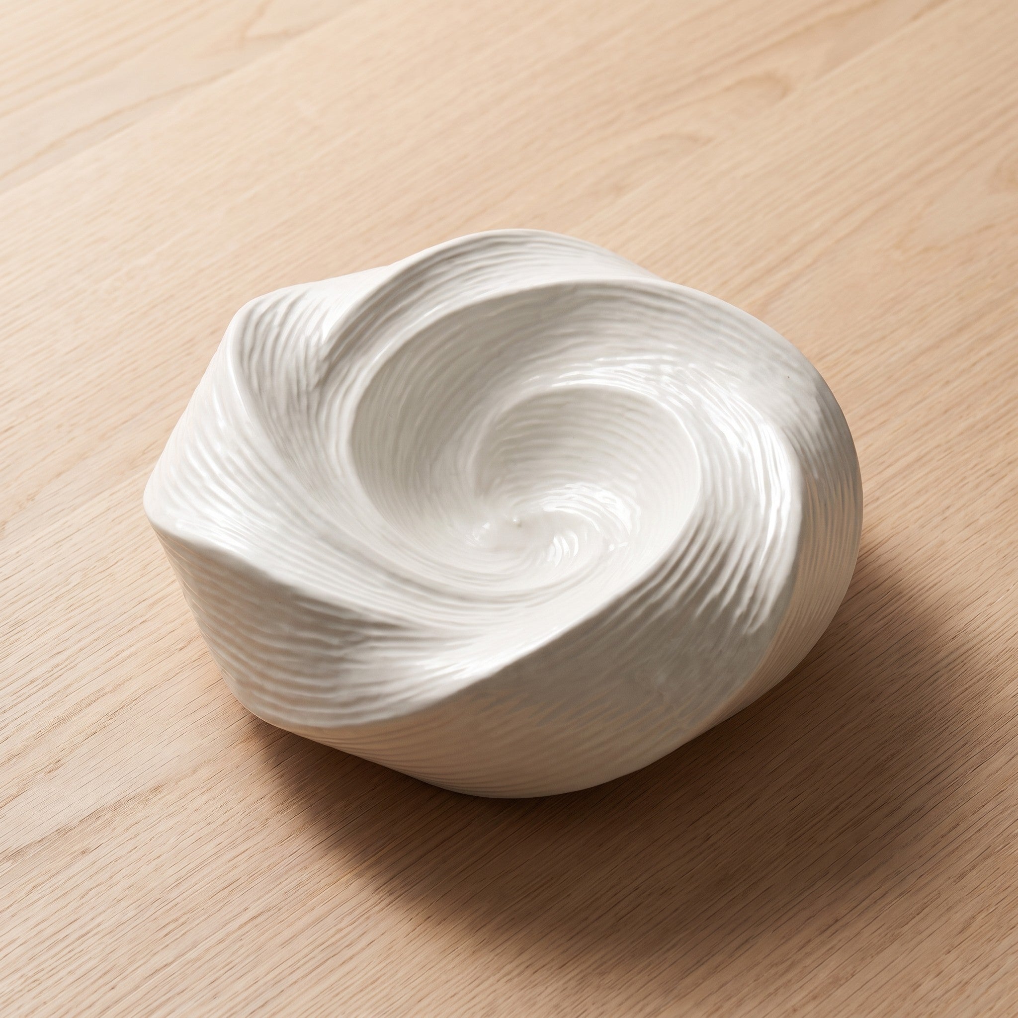 Imara white ceramic serving plate with swirled ridges