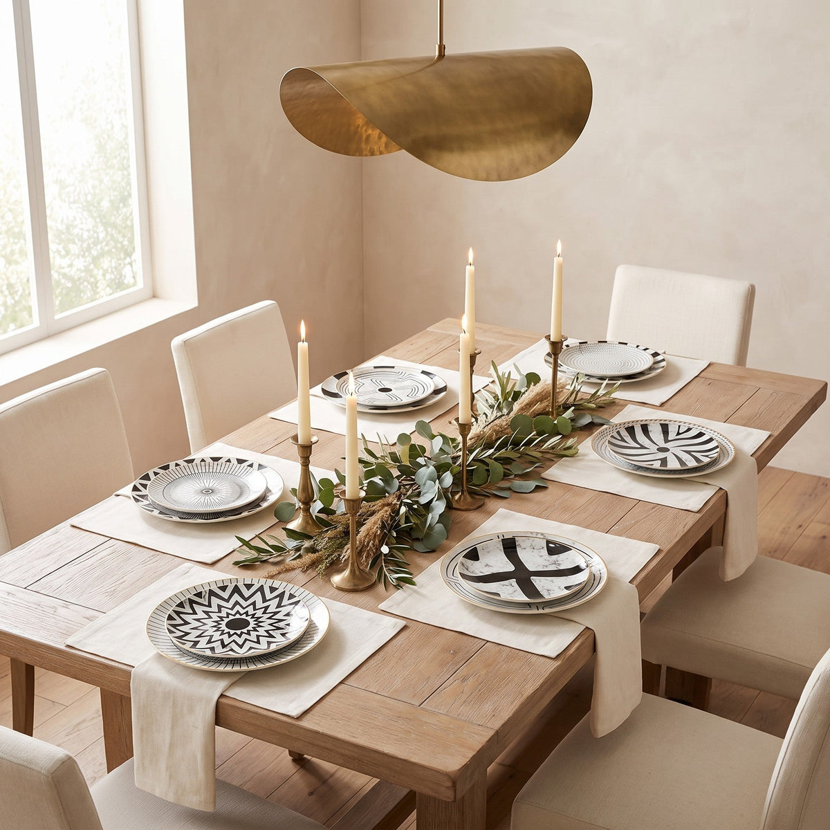 Juno plates on a dining table under a brass pendant light