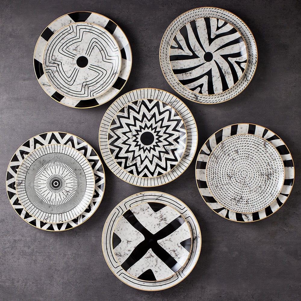 All six Juno plates arranged in a circle on a grey stone surface