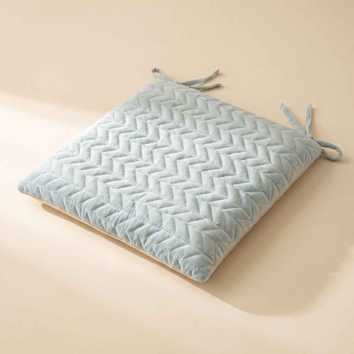 Kairo quilted seat cushion in soft frost blue with diamond quilting and fabric ties, Style Room