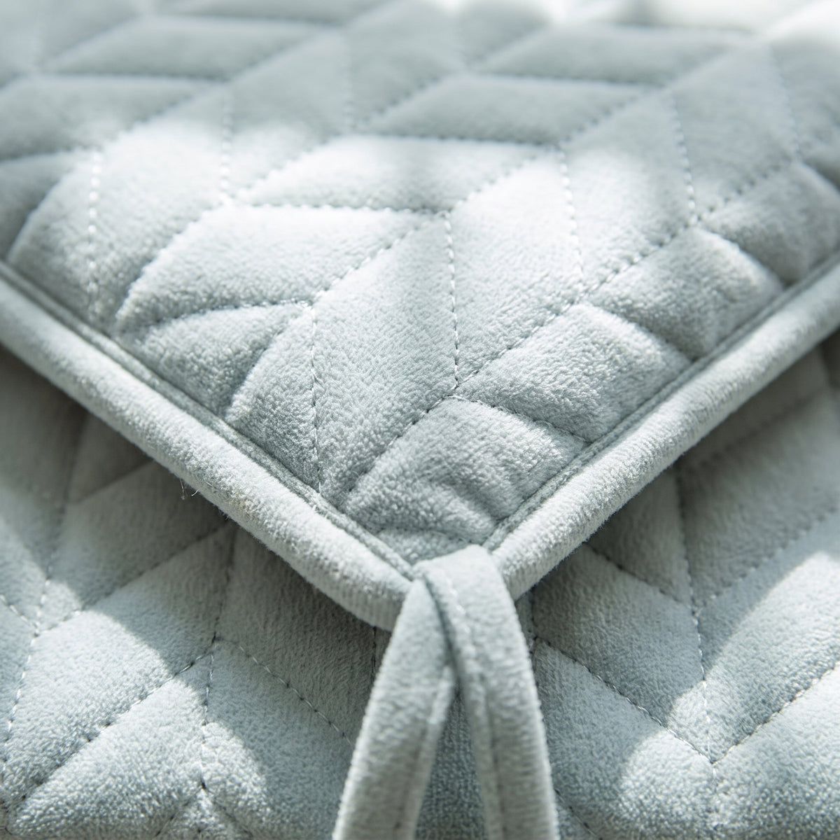 Close-up of the quilted stitching and tie on the Kairo seat cushion, Style Room