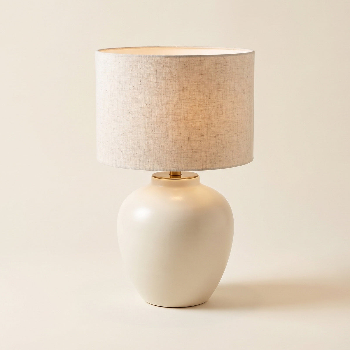 Linnea table lamp with an ivory ceramic base and a natural linen shade, front view