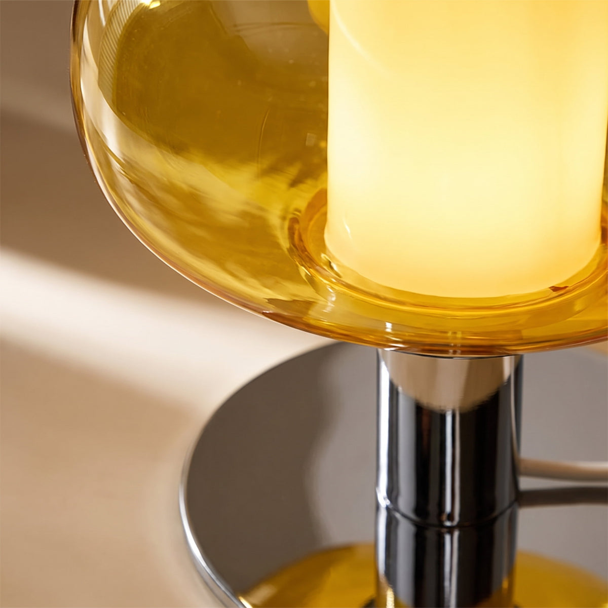 Close detail of the yellow tinted glass dome meeting the chrome stem of the Lolly lamp, Style Room