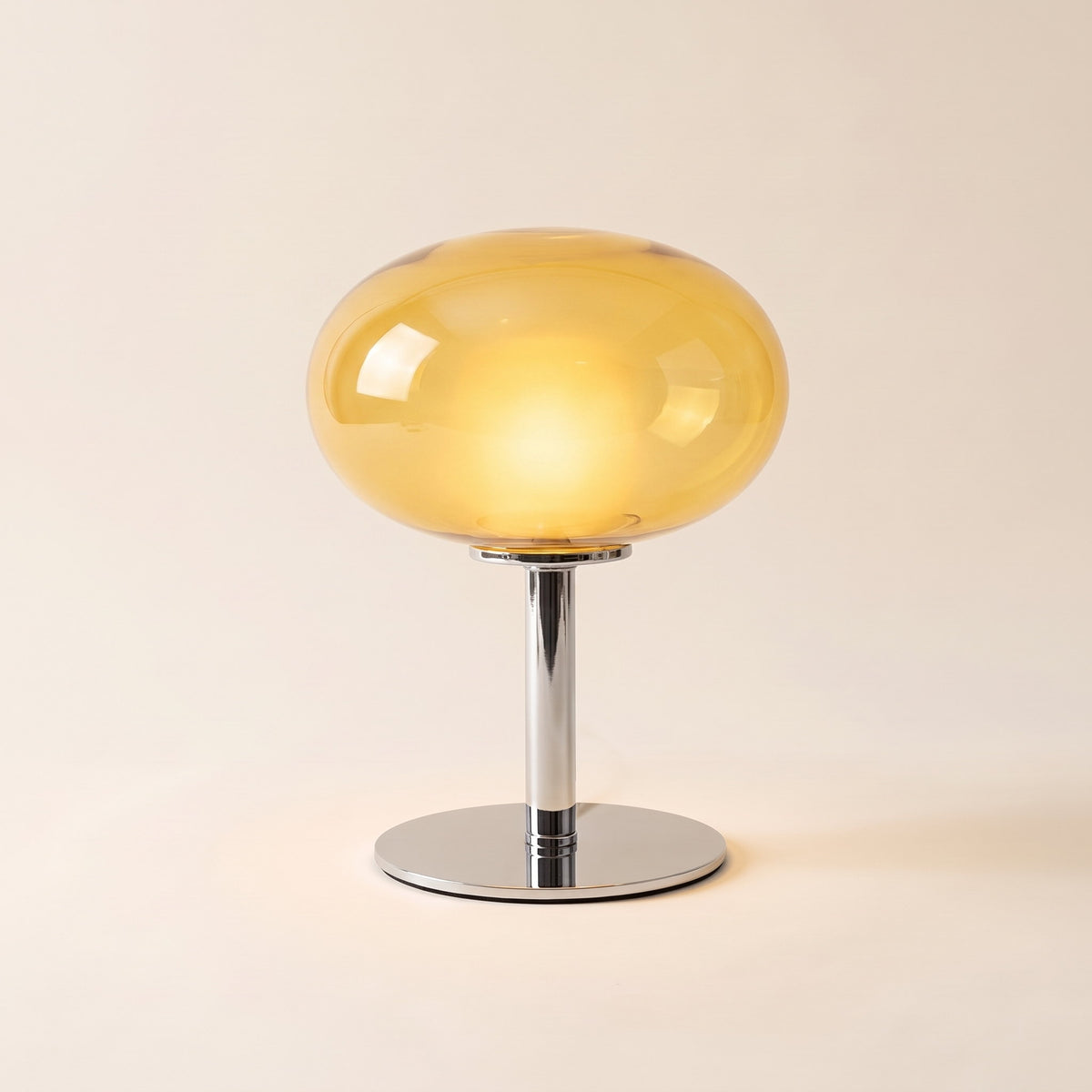 Lolly cordless table lamp with a yellow glass dome, lit, on a cream background, Style Room