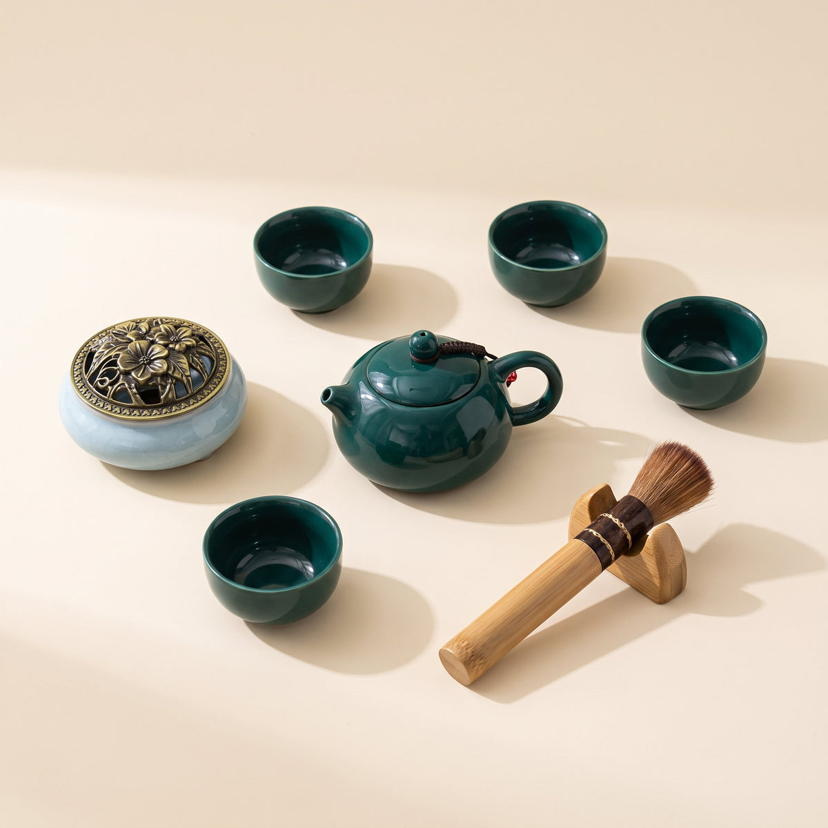 All seven pieces of the Lotus ceramic tea set laid out on a cream background, Style Room