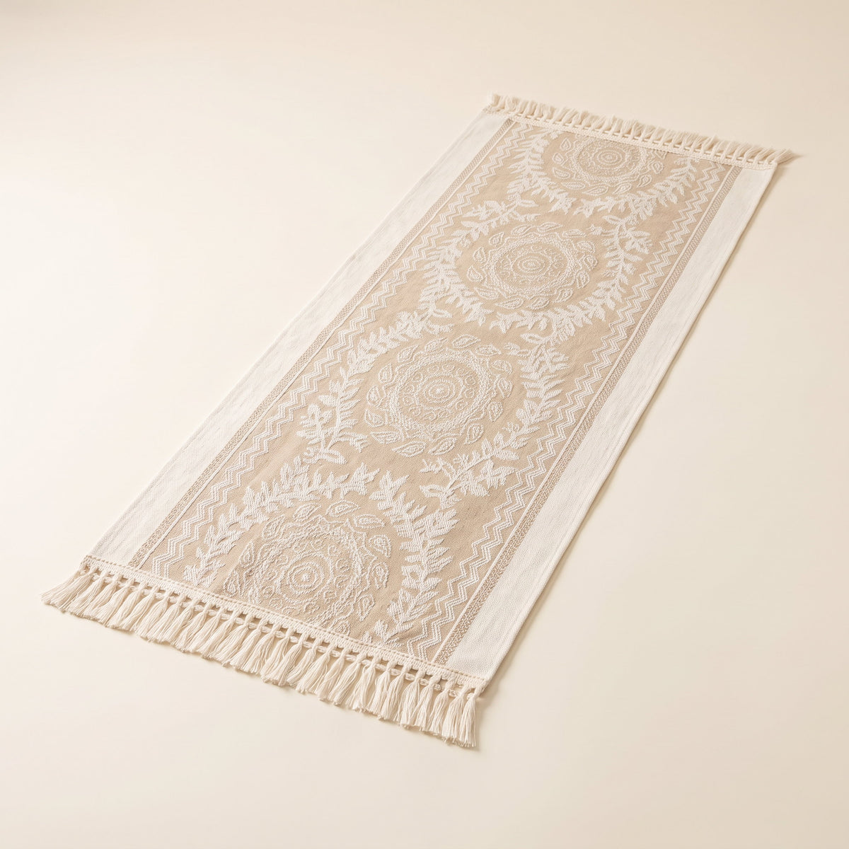 Luna linen-blend table runner laid flat with tasselled edges, full view
