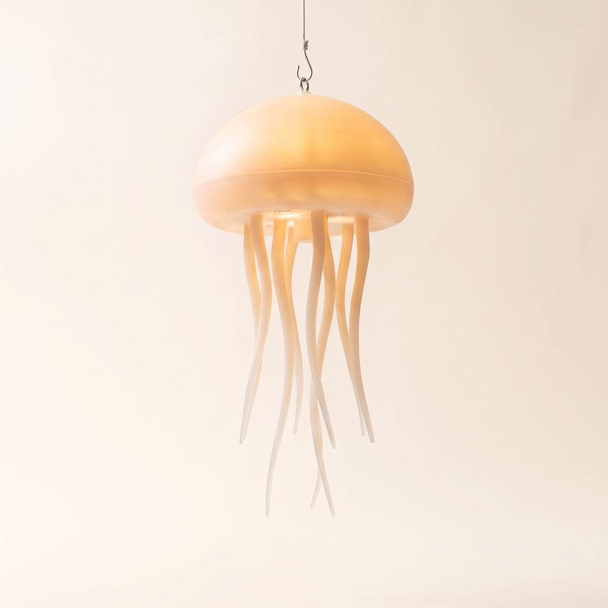 Medusa jellyfish night light hung from a hook with its tentacles trailing down, glowing, Style Room