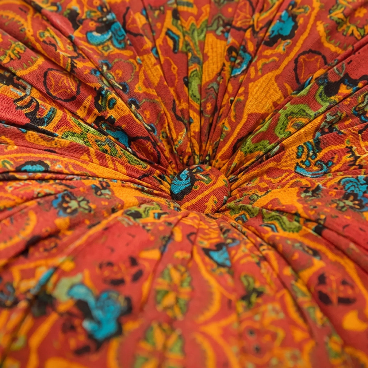 Close-up of the bohemian paisley print and gathered centre of the Mira cushion, Style Room