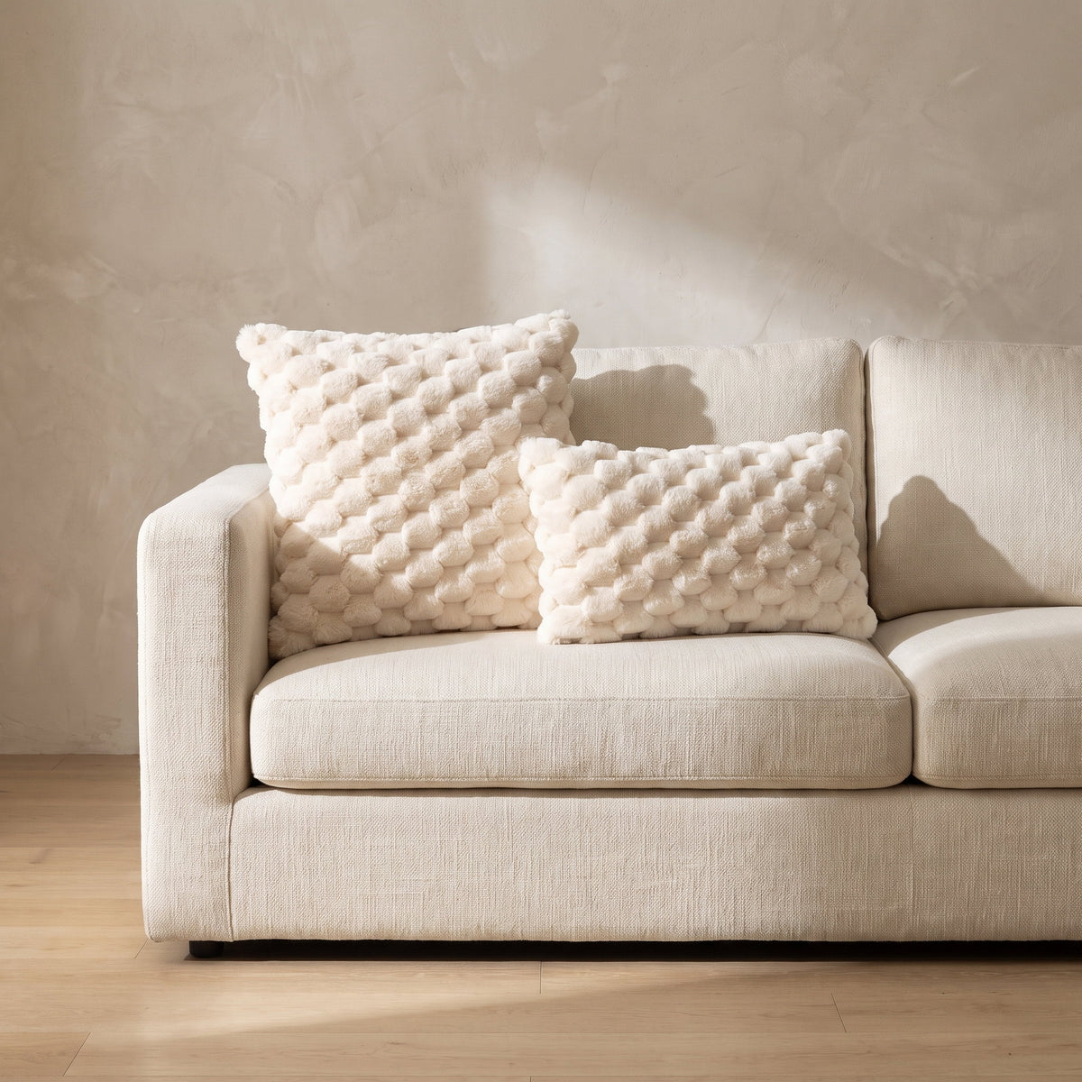 Mira cream plush cushions arranged on a cream linen sofa, Style Room