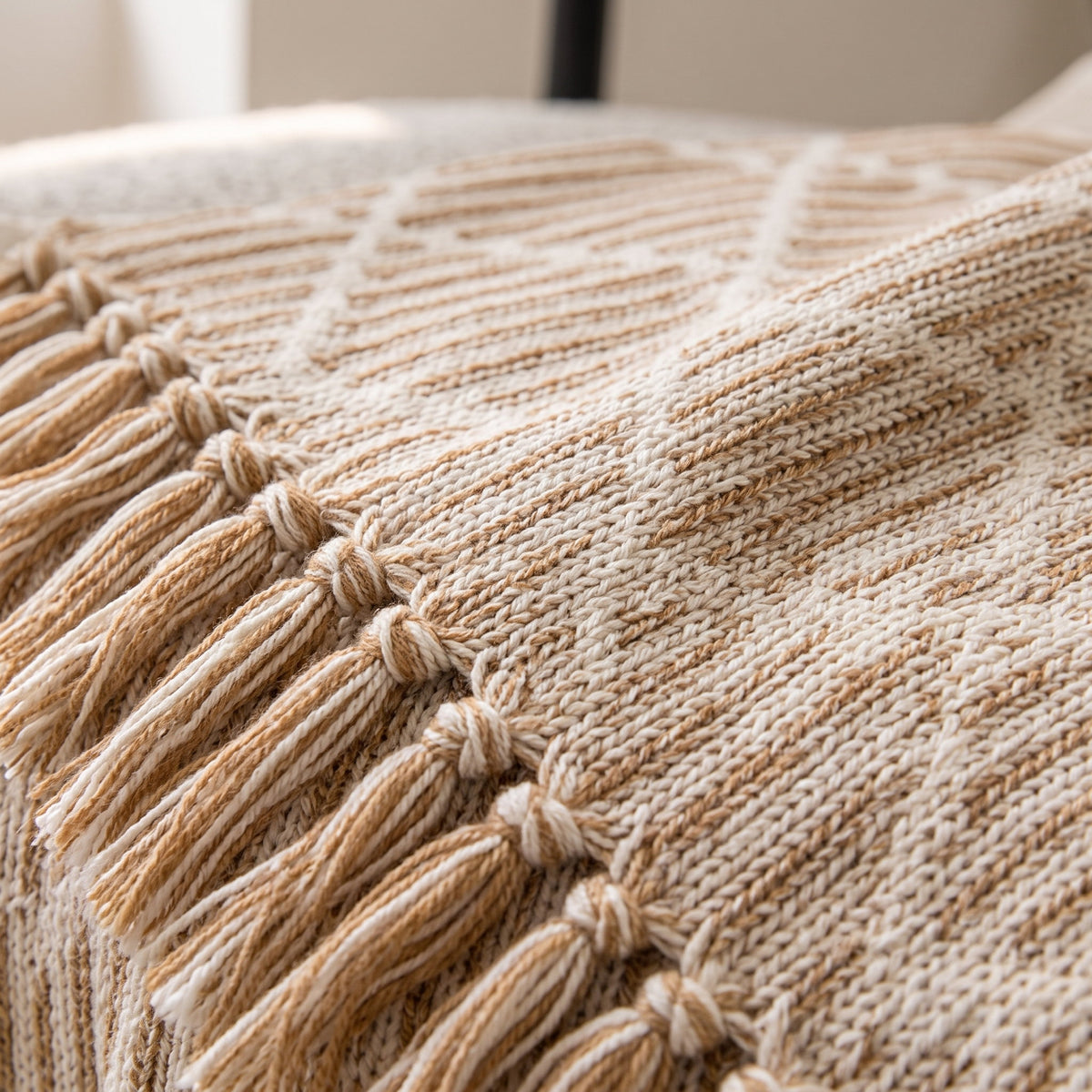 Close-up of the diamond knit and tassel fringe of the Mira throw, Style Room