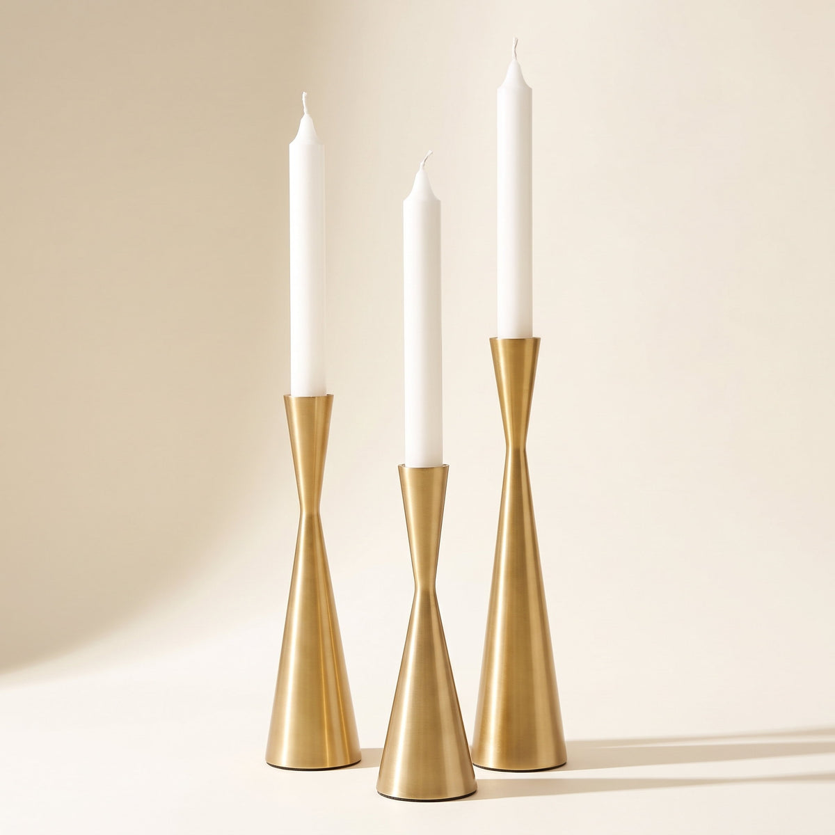Nexa brushed gold brass candlestick set of three with white tapers, Style Room
