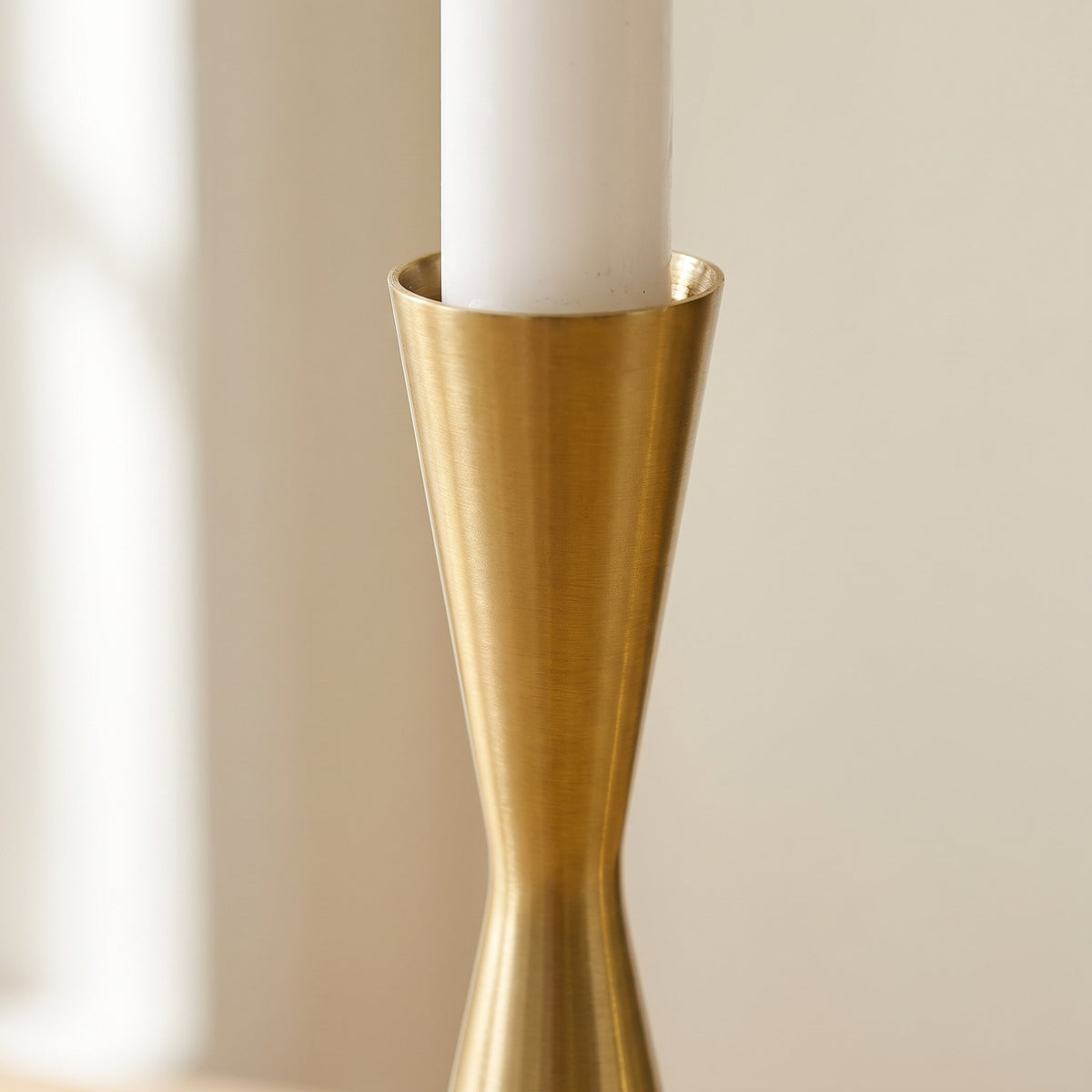 Close-up of the brushed brass cup of the Nexa candlestick, Style Room
