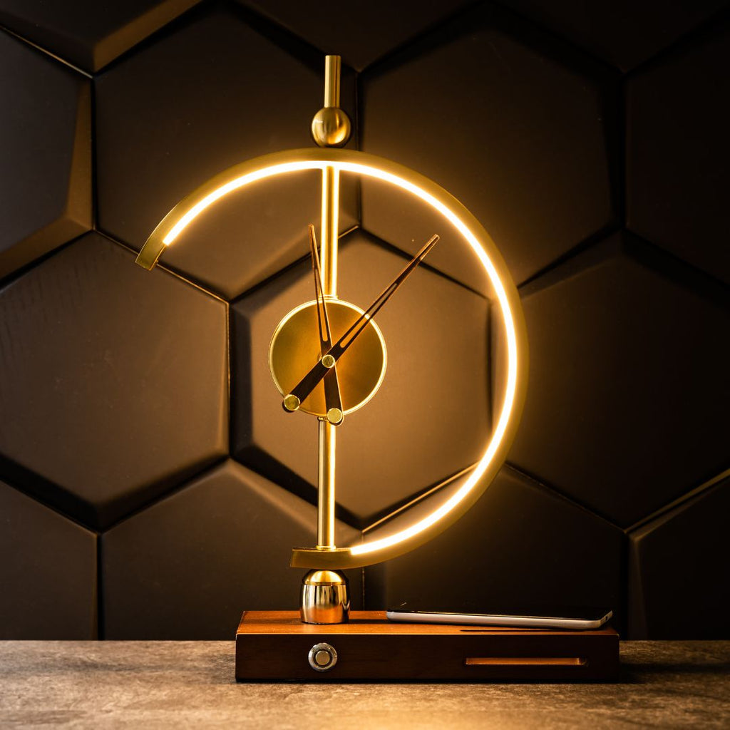 Orin clock lamp lit on a stone surface against a dark panelled wall