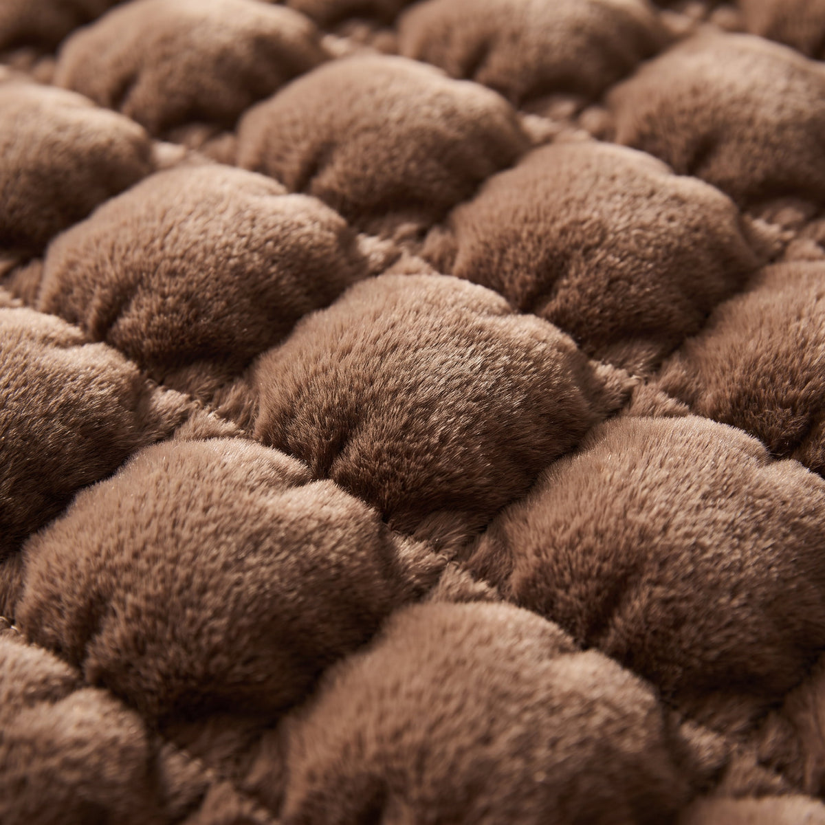 Close-up of the quilted bubble faux-fur pile of the Raven blanket throw, Style Room