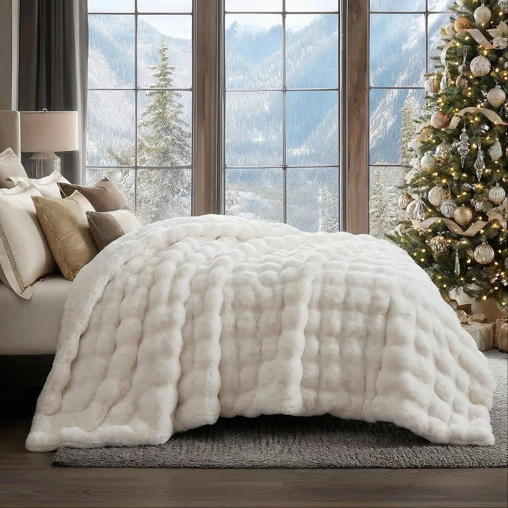 Raven throw in off-white spread across a bed in a room with a mountain view