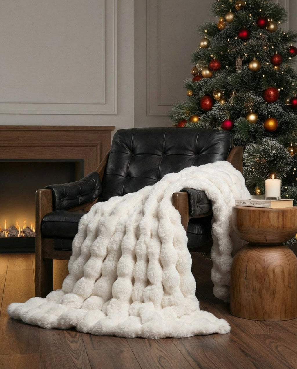 Raven throw in off-white draped over a black leather armchair beside a fireplace