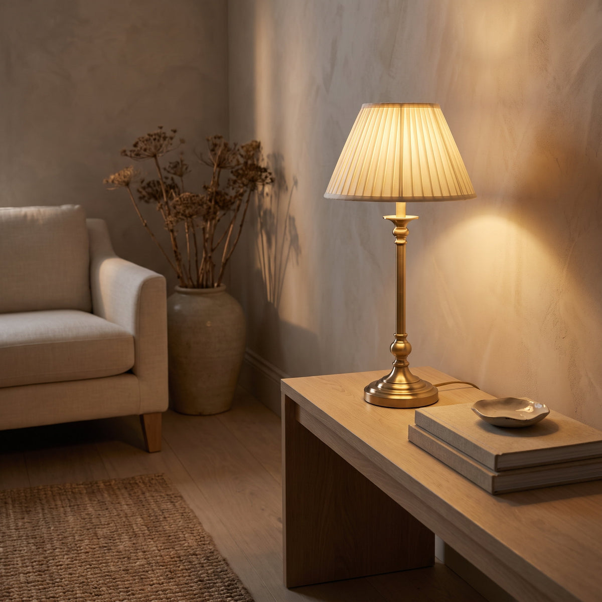 Brushed brass table lamp lit on an oak console in a warm sitting room, Style Room