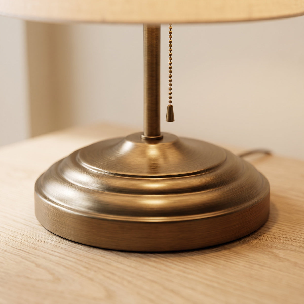 Close-up of the turned brass base and pull chain on the Rowan lamp, Style Room