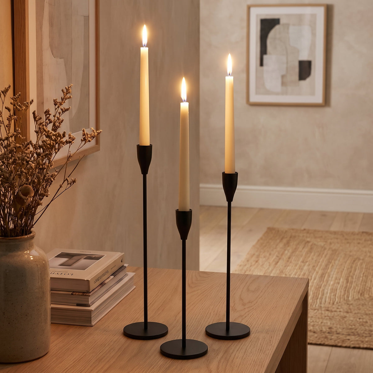 Black taper candlesticks lit on an oak console in a warm sitting room, Style Room